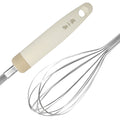Close-up of 290mm stainless steel whisk with brushed finish and beige handle, designed for easy cleaning and silent use.