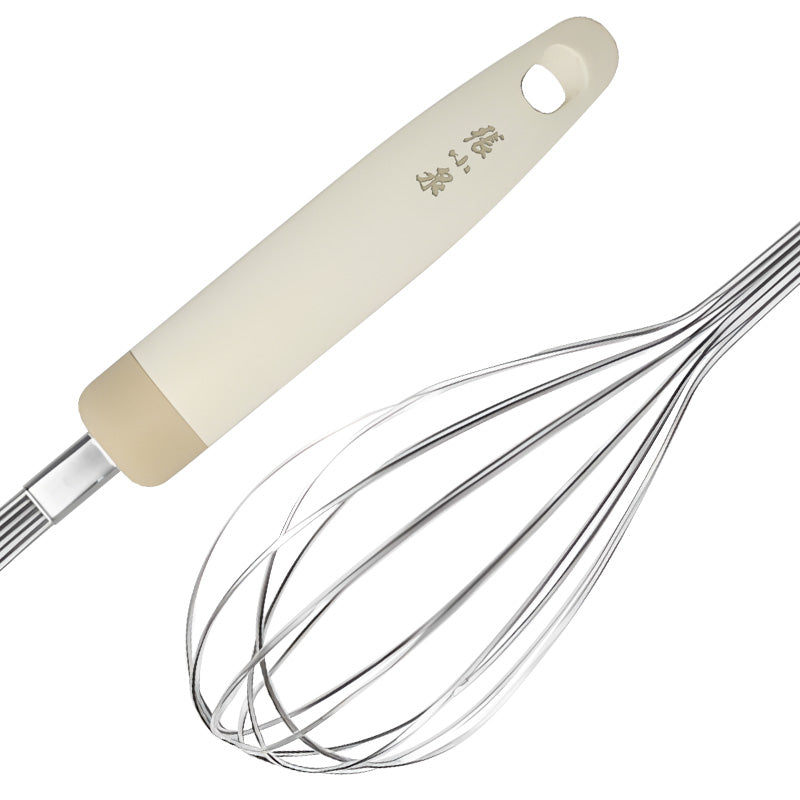 Close-up of 290mm stainless steel whisk with brushed finish and beige handle, designed for easy cleaning and silent use.