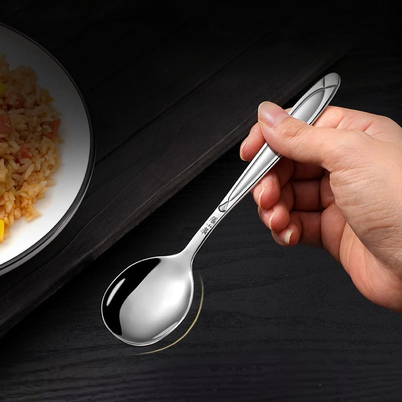 Hand holding the 160mm Ferritic 430 stainless steel spoon, demonstrating its comfortable grip and one-piece molded construction.