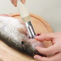 Using the Fish Scale Scraper - 188mm 30Cr13 Steel | Zhang Xiaoquan AU to clean fish head, demonstrating its sharp and ergonomic design.