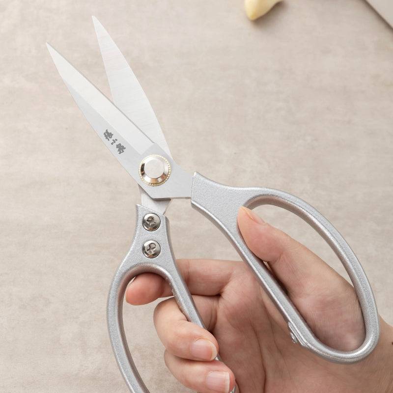 Zhang Xiaoquan AU 210mm kitchen scissors shown in hand, highlighting comfortable grip and sharp 40Cr13 steel blades for versatile food prep tasks.