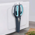245mm kitchen scissors stored vertically on a fridge using included magnetic holder, showcasing space-saving kitchen storage.