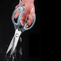 Waterproof 245mm kitchen scissors being rinsed under running water, highlighting easy cleaning and durable construction.