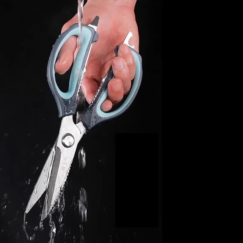 Waterproof 245mm kitchen scissors being rinsed under running water, highlighting easy cleaning and durable construction.