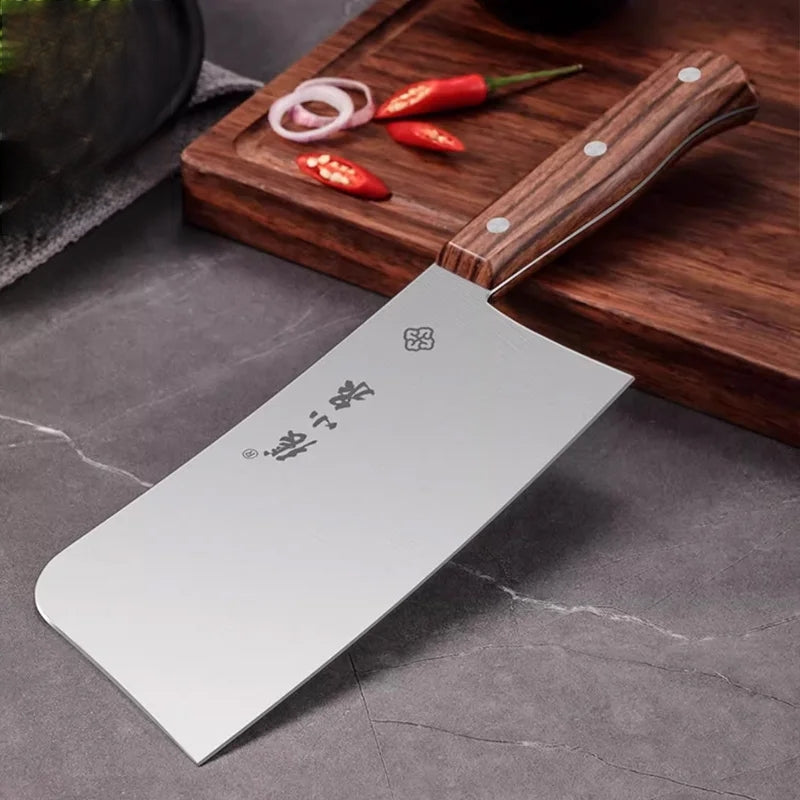 Zhang Xiaoquan 310mm meat cleaver resting on kitchen counter, showcasing 30Cr13 steel blade and ergonomic wooden handle for bone chopping.