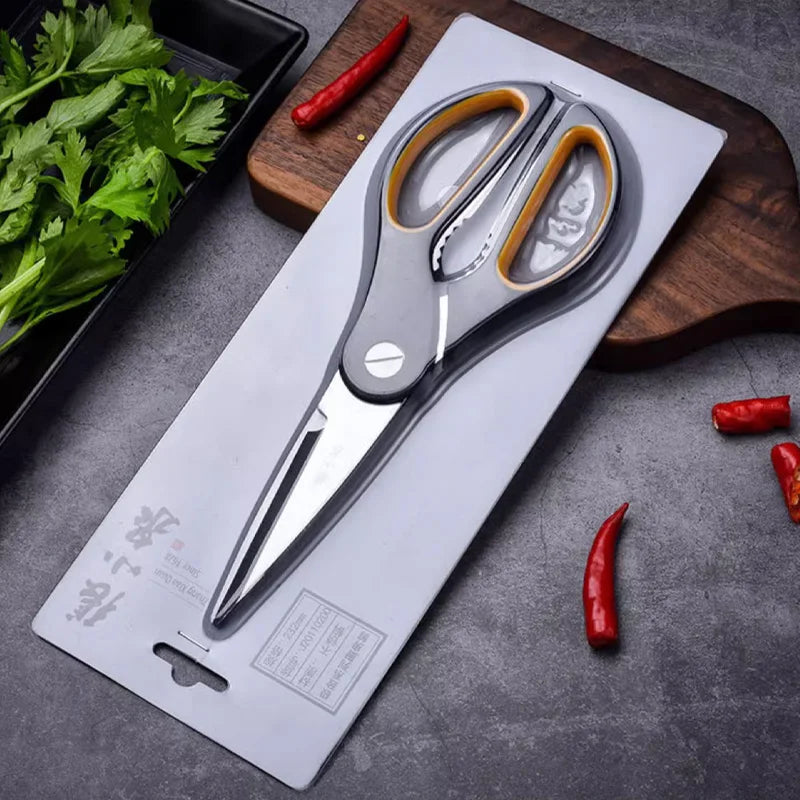 Zhang Xiaoquan AU 230mm kitchen scissors in retail packaging on a kitchen counter. Heavy-duty shears for home and garden use.