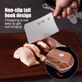 310mm 30Cr13 meat cleaver in use cutting poultry, highlighting non-slip tail hook design for safe and controlled chopping in kitchen tasks.