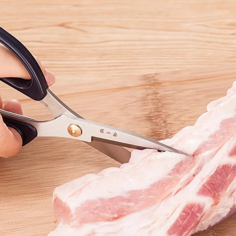 185mm 30Cr13 Multi-Purpose Scissors slicing raw pork, showcasing strength and precision for meat cutting in kitchen use.