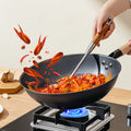 32cm Zhang Xiaoquan AU iron wok in action on gas stove, stir-frying spicy crayfish with high heat and no chemical coating.