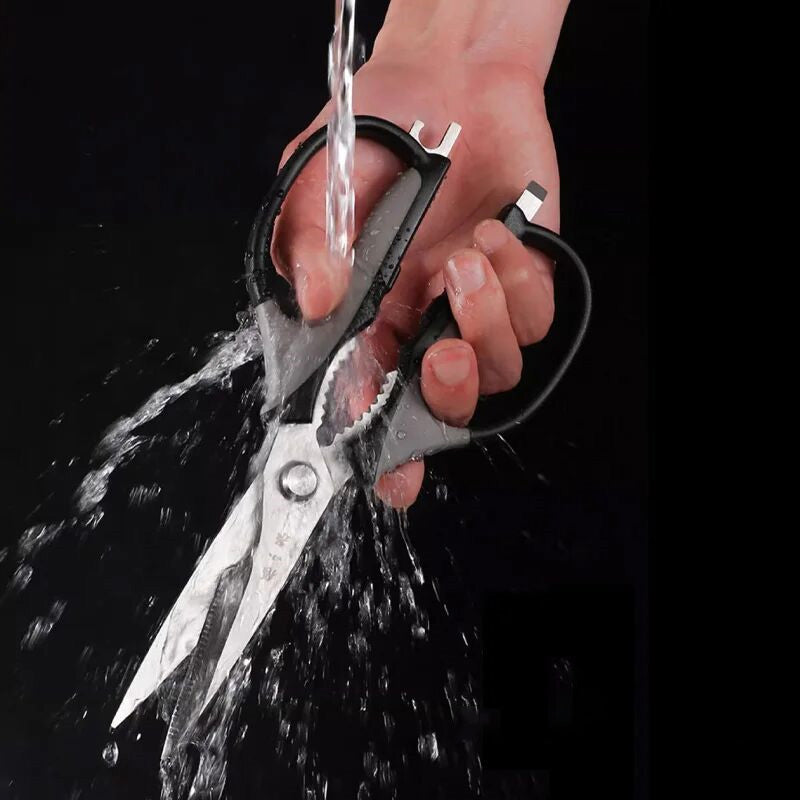 Water-resistant 5-in-1 kitchen scissors being washed under running water, highlighting easy cleaning and rust-resistant design.