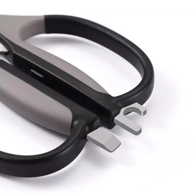 Detail of multifunction kitchen scissors' handle with built-in bottle opener and nutcracker, made from durable ABS+TPR material.