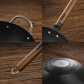 Close-up of 34cm nitrided iron wok details including wooden handle, helper handle, and induction-safe base design.