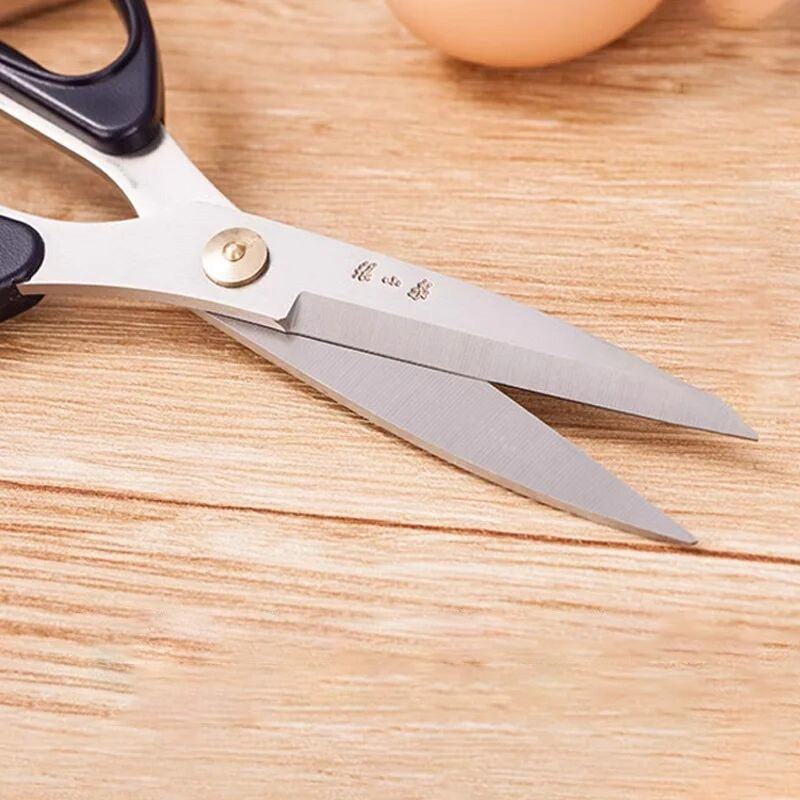 185mm 30Cr13 Multi-Purpose Scissors with partially open blades on a wooden surface, ideal for fabric, meat, and vegetable cutting.