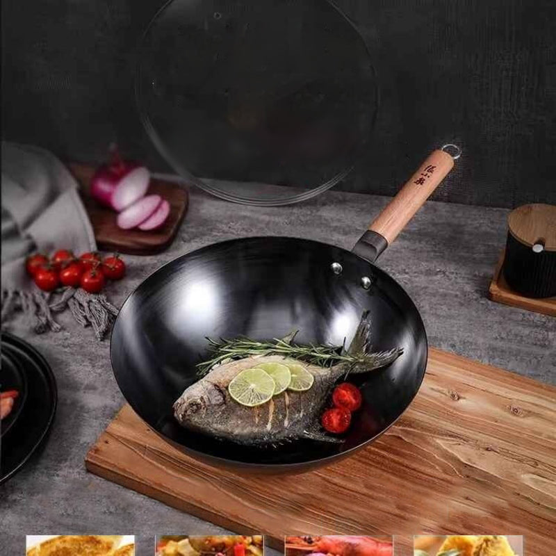 Iron wok in use, cooking fish with garnishes on a wooden board.