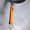 Close-up of wooden handle with loop, ergonomic and sturdy design.