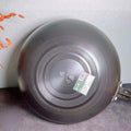 Back view of nitrided iron pan with circular grooves for even heating.