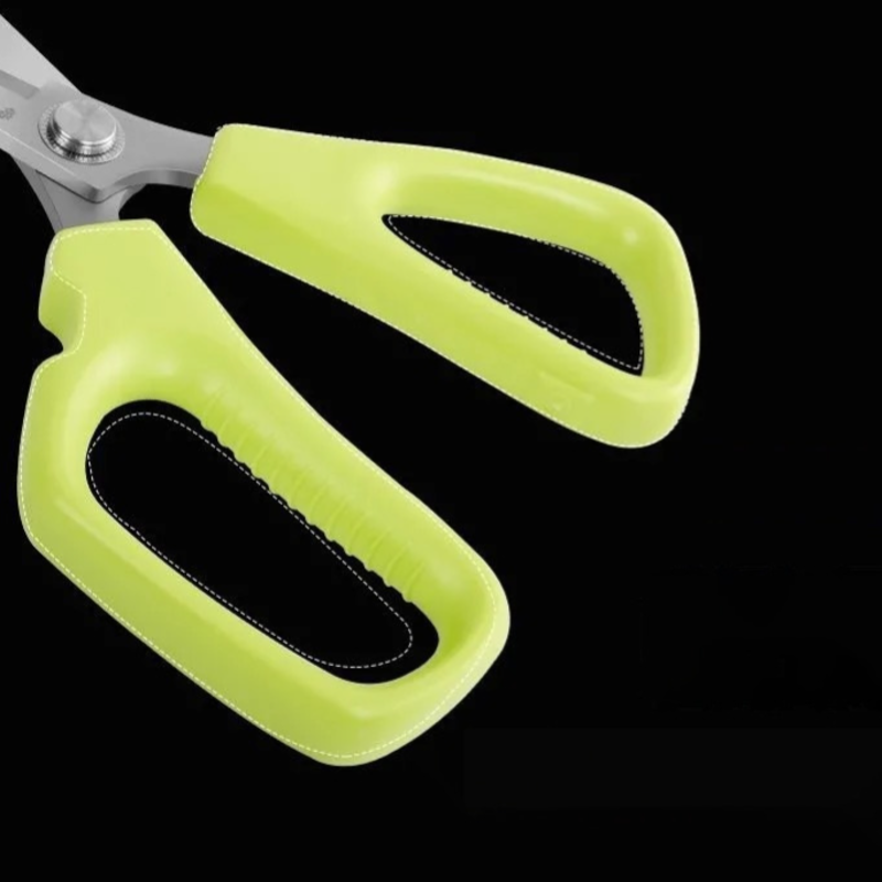 Ergonomic green ABS handles of durable kitchen scissors for comfortable grip.