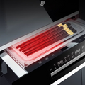 Heat-resistant black chopsticks in a dishwasher with red heat indicator.