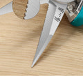 Close-up of micro-serrated stainless steel blades of pruning scissors.