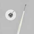 Close-up of ear pick tool with stainless steel tip for precision cleaning.