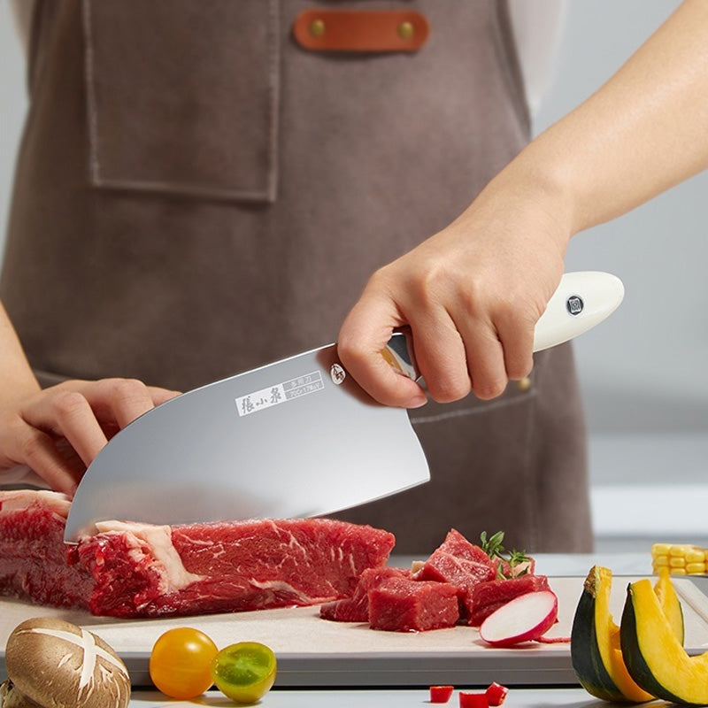 70Cr17MoV Steel Chinese Chef Knife cutting raw meat on a wooden cutting board, surrounded by fresh vegetables. Ideal for precision kitchen tasks.