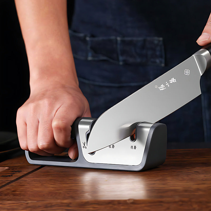 Person sharpening a knife using the diamond abrasive kitchen sharpener.