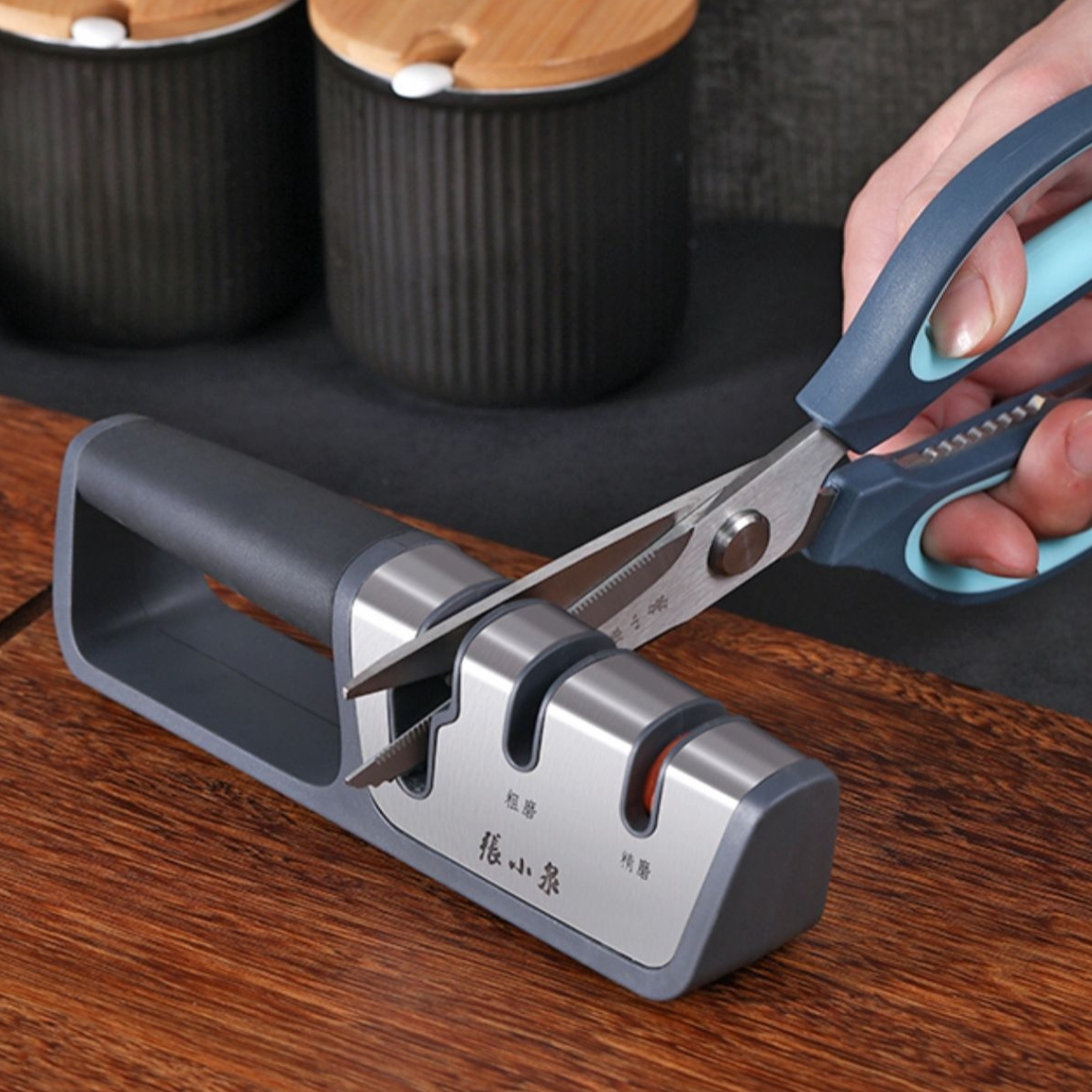 Scissors being sharpened with the multi-functional knife sharpener.