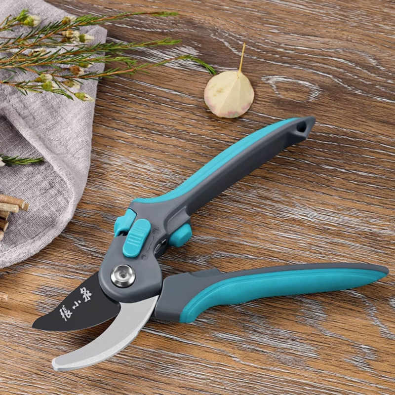 Pruning shears placed on a wooden surface with gardening decor.