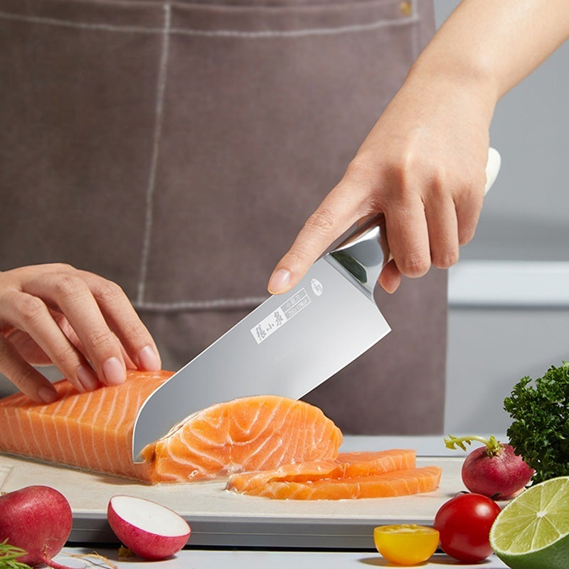 70Cr17MoV Steel Chinese Chef Knife slicing fresh salmon fillet on a cutting board, surrounded by radishes, lime, and parsley. Ideal for precision kitchen tasks.