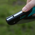 Close-up of a 235mm 65Mn folding saw with a secure locking mechanism, part of a heavy-duty garden tool set for pruning and cutting.