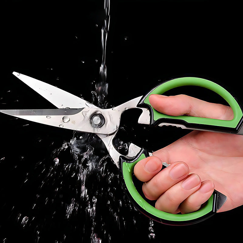 Water-resistant kitchen scissors being rinsed under running water.