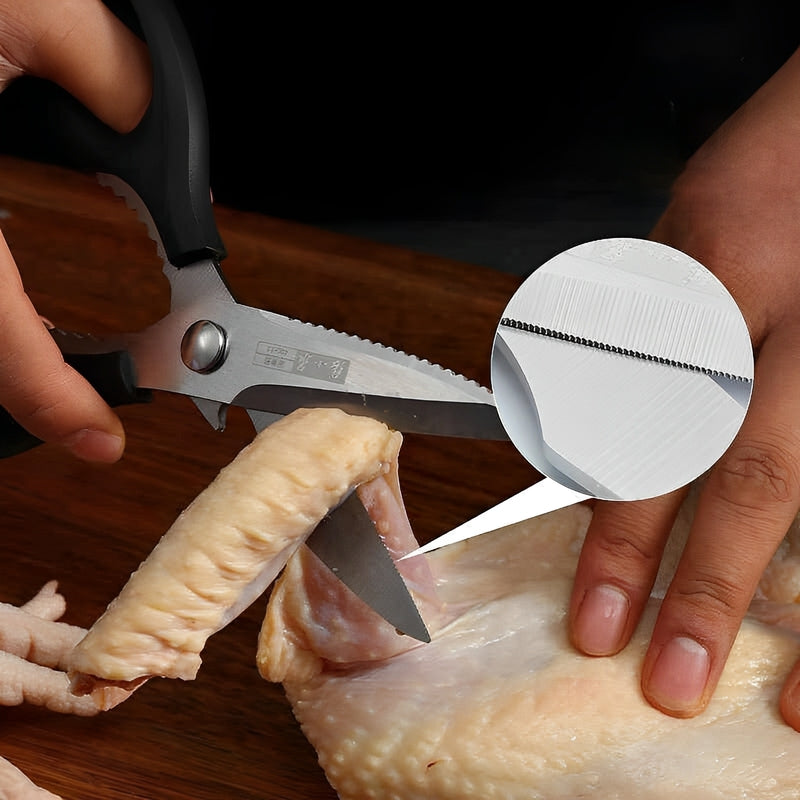 200mm kitchen shears cutting through raw chicken, showcasing their sharp and precise serrated blades.