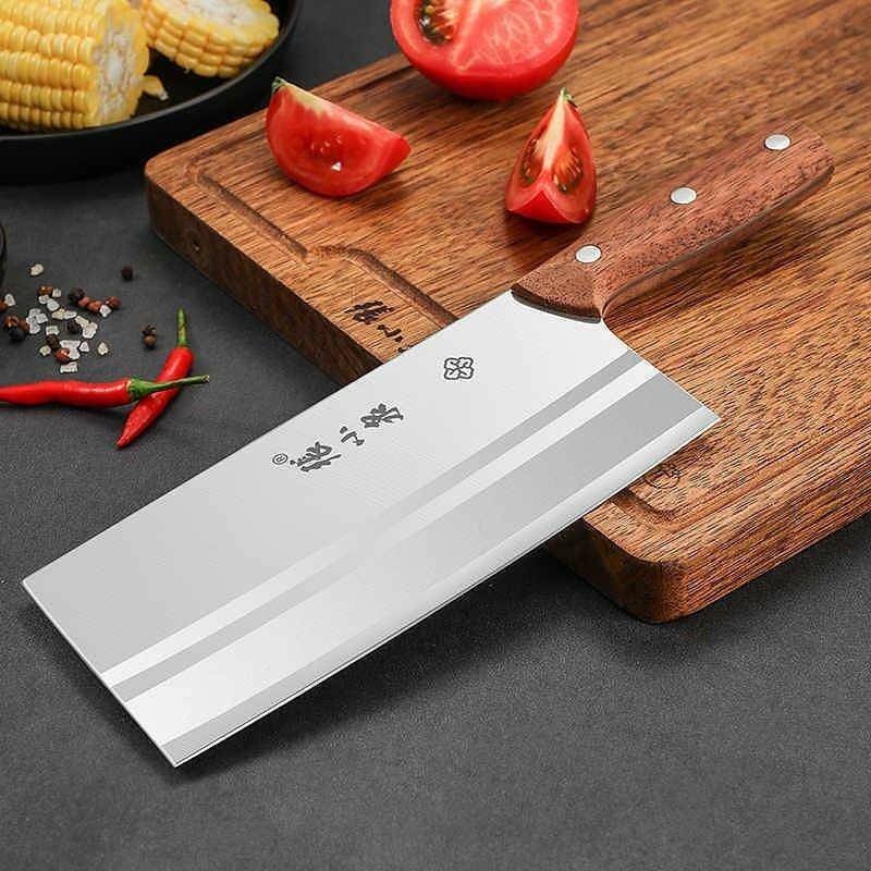 Professional Chinese cleaver on a cutting board with fresh vegetables.