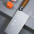 Close-up of a 40Cr13 steel chef's knife with a wooden handle on a kitchen surface.