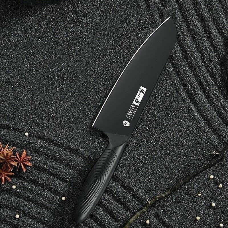 Antibacterial chef's knife displayed on textured black surface with spices.