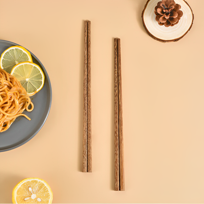 Set of 5 chicken wing wood chopsticks with natural grain texture.