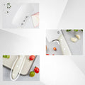 Close-up of Chinese cleaver blade and ergonomic white ABS handle with food prep items.