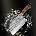 Hammer-forged chopper knife with water splashing around it on a dark background.