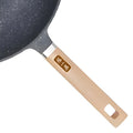 Wooden handle of volcanic rock wok with engraved branding detail.