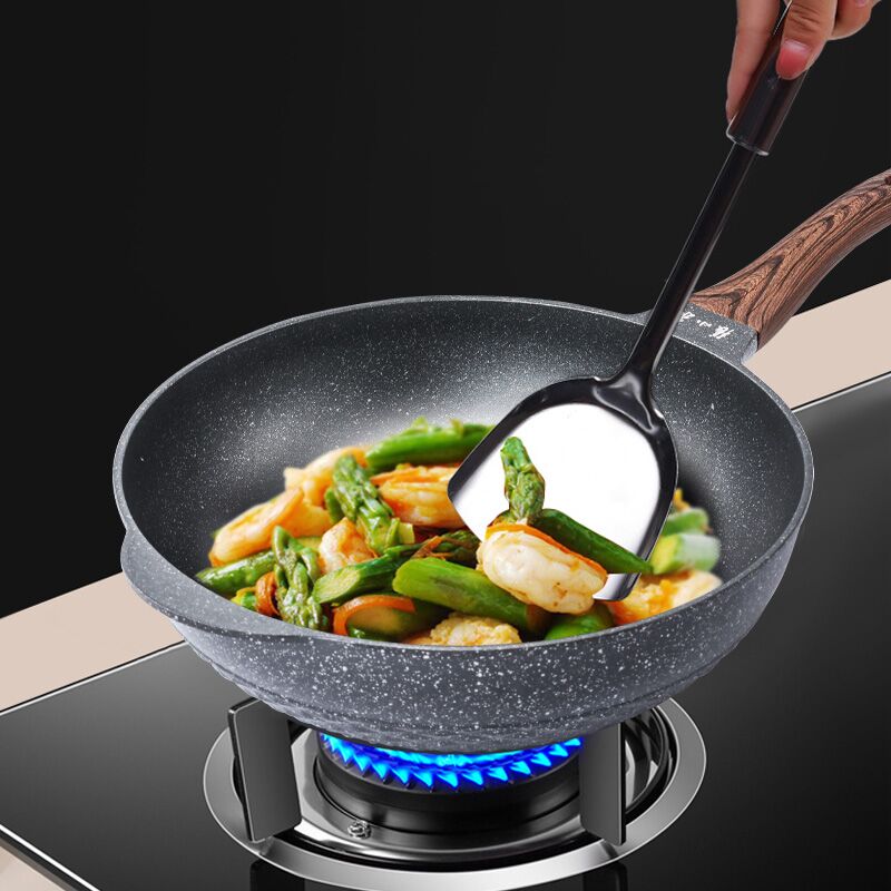 32cm non-stick wok pan in use, cooking vegetables and shrimp on a gas stove.