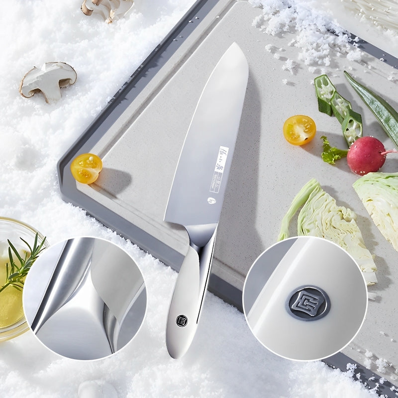 Premium chef knife displayed with fresh vegetables on a snowy surface.