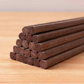 Close-up view of stacked sandalwood chopsticks showcasing their unique texture.