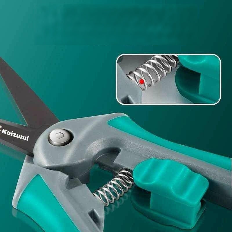 Pruning shears with spring mechanism and ergonomic green handle design.