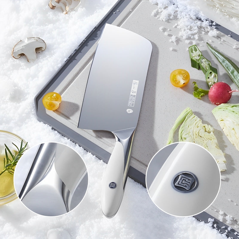 The Chef's Cutting & Sharpening Kit featuring a 305mm cleaver with a sleek stainless steel blade and ergonomic handle, displayed on a cutting board with fresh vegetables in a snowy setting.